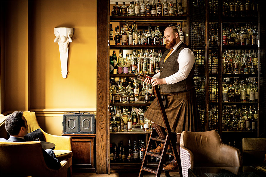The_Balmoral_-_SCOTCH_-_Cameron_Ewen_at_whisky_wall