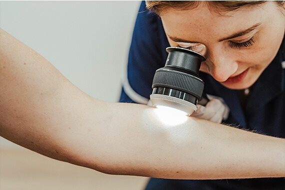 Checking for moles at the Mole Clinic Microscope